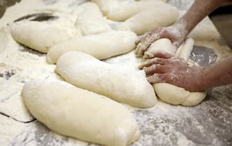 A baker kneading dough by hand. Photographer: Alessia Pierdomenico/Bloomberg