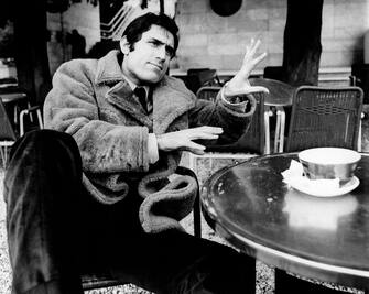The Sicilian actor Lando Buzzanca (born Gerlando Buzzanca) seated at a table of an outdoor cafÃ©, is gesticulating and smiling; the actor is wearing a sheepskin coat. Rome (Italy), 1970. (Photo by Mondadori via Getty Images)