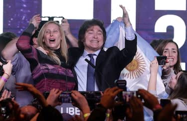 Argentine far-right libertarian economist and presidential candidate Javier Milei celebrates the results of the primary elections with his sister Karina Milei at his headquarters in Buenos Aires on August 13, 2023. The far-right libertarian economist Javier Milei gets 32.31% of the votes in the primaries for the Argentine presidential election, and becomes the protagonist of this election that will contest the former Security Minister Patricia Bullrich and the Economy Minister Sergio Massa. (Photo by ALEJANDRO PAGNI / AFP) (Photo by ALEJANDRO PAGNI/AFP via Getty Images)