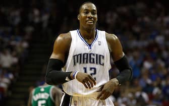ORLANDO, FL - MAY 18:  Dwight Howard #12 of the Orlando Magic smiles as he looks on against the Boston Celtics in Game Two of the Eastern Conference Finals during the 2010 NBA Playoffs at Amway Arena on May 18, 2010 in Orlando, Florida.  NOTE TO USER: User expressly acknowledges and agrees that, by downloading and/or using this Photograph, user is consenting to the terms and conditions of the Getty Images License Agreement.  (Photo by Doug Benc/Getty Images)