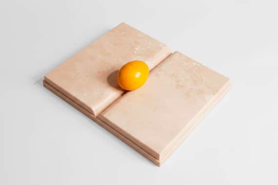 Mirella Bentivoglio, Libro Uovo Giallo, 2000, travertino e marmo giallo, 21 × 26 × 3 cm