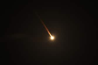 epaselect epa11636221 A projectile flies over the Upper Galilee, northern Israel, 01 October 2024. Israel's military stated that Iran has launched missiles towards the State of Israel on 01 October, and asked citizens to 'remain vigilant' and to follow the Home Front Command's instructions directing people to protected areas and remain there 'until further instructions' are given.  EPA/ATEF SAFADI