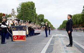 France's President Emmanuel Macron reviews the troops during the Bastille Day military parade on the Champs-Elysees avenue in Paris on July 14, 2023. (Photo by GONZALO FUENTES / POOL / AFP) (Photo by GONZALO FUENTES/POOL/AFP via Getty Images)