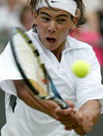 epa11652167 (FILE) -  Spain's Rafael Nadal plays a backhand during his third round match against Paradorn Srichaphan of Thailand at the All England Lawn Tennis Championships in Wimbledon, Friday 27 June 2003. (reissued 10 October 2024). On 10 October 2024, Rafael Nadal of Spain announced that he will retire from professional tennis. Since winning his first ever title in 2004, Nadal won 92 titles, including 22 grand slams and a record 14 French Open titles.  EPA/SRDJAN SUKI *** Local Caption *** 99252365