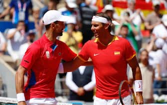 epa11652233 (FILE) -  Rafael Nadal (R) of Spain and Novak Djokovic of Serbia greet each other ahead of their Men's Singles second round match at the Tennis competitions in the Paris 2024 Olympic Games, at the Roland Garros in Paris, France, 29 July 2024 (reissued 10 October 2024). On 10 October 2024, Rafael Nadal of Spain announced that he will retire from professional tennis. Since winning his first ever title in 2004, Nadal won 92 titles, including 22 grand slams and a record 14 French Open titles.  EPA/FRANCK ROBICHON