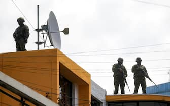 epa11067813 Members of the military stand guard at the Radio Canela station, where the Ecuadorian president Daniel Noboa (not pictured) arrived to offer statements about the recent wave of violence in the country, in Quito, Ecuador, 10 January 2024. Riots began on 08 January in at least six prisons across the country, which saw several prison guards being taken hostage leading President Daniel Noboa to declare a state of emergency. Guayaquil, Ecuador's largest city, was the hardest hit by the disturbances. At least 10 people were killed there on 09 January night, two of them police officers, and armed hooded men stormed a television station during a live broadcast.  EPA/JOSE JACOME