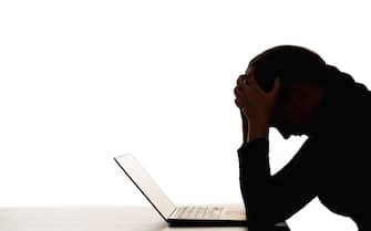 female silhouette overwork burnout woman laptop