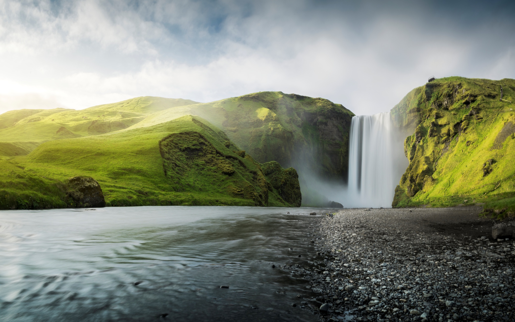 Waterfall with green landscape and river