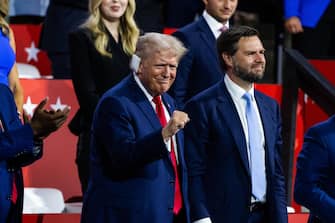 epa11480844 Republican presidential nominee and former President Donald Trump (L) alongside his vice presidential nominee JD Vance (R), look on during the evening session on the opening day of the Republican National Convention (RNC) at the Fiserv Forum in Milwaukee, Wisconsin, USA, 15 July 2024. The convention comes just a few days after a 20-year-old Pennsylvania man attempted to assassinate former president and current Republic presidential nominee Donald Trump. The RNC is being held 15 to 18 July 2024 and is where delegates from the Republican Party select their nominees for president and vice president in the 2024 US presidential election.  EPA/JIM LO SCALZO