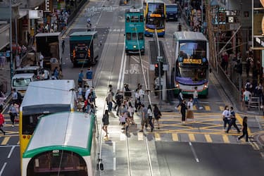 epa10299357 Pedestrians cross an intersection in Hong Kong, China, 11 November 2022. Hong Kong's Hang Seng Index advanced the most in over eight months after China eased some of its Covid-19 restrictions.  EPA/JEROME FAVRE