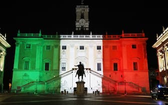 ROME, ITALY - MARCH 17: The colors of the Italian flag are projected onto the Palazzo Senatorio building on Capitoline Hill (Campidoglio) in the historic city center as a van of the Italian Red Cross passes by during the distribution of 50 meals to homeless people on March 17, 2020 in Rome, Italy.
Homeless people are trapped in still cities, many assistance centers are closed due to possible contagion, some associations have stopped or slowed down their assistance activities.Nobody begs because nobody can leave the house, and without money you can't buy anything and the shops are almost all closed. Homeless people have become an emergency within the emergency. 
(Photo by Marco Di Lauro/Getty Images)