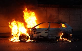 A photo shows a burning car on the sidelines of a demonstration in Nanterre, west of Paris, on June 27, 2023, after French police killed a teenager who refused to stop for a traffic check in the city. The 17-year-old was in the Paris suburb early on June 27 when police shot him dead after he broke road rules and failed to stop, prosecutors said. The event has prompted expressions of shock and questions over the readiness of security forces to pull the trigger. (Photo by Zakaria ABDELKAFI / AFP) (Photo by ZAKARIA ABDELKAFI/AFP via Getty Images)