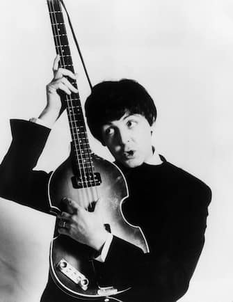 circa 1965:  Paul McCartney of The Beatles with his Hohner bass.  (Photo by Express/Express/Getty Images)