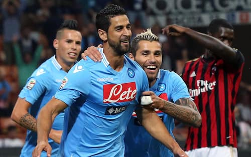 Napoli's defender Miguel Britos (L) celebrates with teammate midfielder Valon Behrami after scoring the 1-0 lead during the Serie A soccer match beween AC Milan and Napoli at the Giuseppe Meazza stadium in Milan, Italy, 22 September 2013. ANSA/MATTEO BAZZI