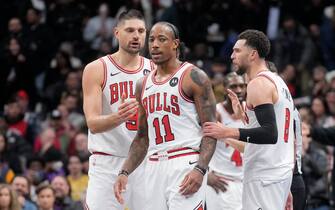 TORONTO, ON - NOVEMBER 24: DeMar DeRozan #11 of the Chicago Bulls reacts at the end of the second half with teammates Nikola Vucevic #9 (L) and Zach LaVine #8 (R) in the NBA In-Season Tournament game against the Toronto Raptors at the Scotiabank Arena on November 24, 2023 in Toronto, Ontario, Canada. NOTE TO USER: User expressly acknowledges and agrees that, by downloading and/or using this Photograph, user is consenting to the terms and conditions of the Getty Images License Agreement. (Photo by Mark Blinch/Getty Images)