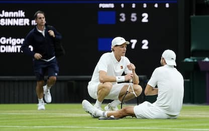 Jannik Sinner (left) checks on Grigor Dimitrov after he went down injured during their Gentlemen's Singles match on day eight of the 2025 Wimbledon Championships at the All England Lawn Tennis and Croquet Club, London. Picture date: Monday July 7, 2025. (Photo by Jordan Pettitt/PA Images via Getty Images)