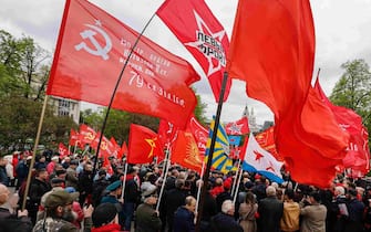 epa10601861 Members of Russian Communist party hold Red flags as they take part in the traditional May Day celebrations near the Karl Marx monument in Moscow, Russia, 01 May 2023. International Workers' Day is an annual holiday that takes place on 01 May and celebrates workers, their rights, achievements and contributions to society.  EPA/SERGEI ILNITSKY