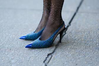 NEW YORK, NEW YORK - FEBRUARY 15: Miki Cheung wears black fishnet with embroidered rhinestones pattern tight, blue and green checkered tweed pointed pumps heels shoes, outside Marrisa Wilson, during New York Fashion Week, on February 15, 2022 in New York City. (Photo by Edward Berthelot/Getty Images)