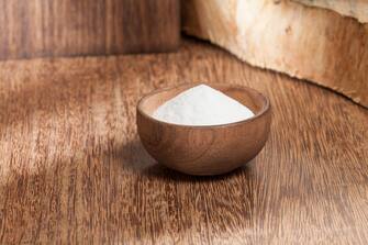 baking soda (sodium bicarbonate) in a wooden bowl; Photo on wooden background.