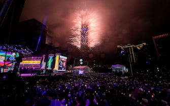 TAIPEI, TAIWAN - JANUARY 01: People celebrate as fireworks light up the skyline from the Taipei 101 building during New Year's celebrations on January 01, 2023 in Taipei, Taiwan. (Photo by Gene Wang/Getty Images)
