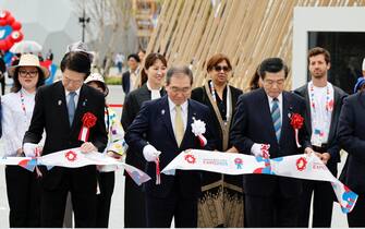 epa12028421 Masakazu Tokura (C), Chairperson for the Japan Association for the 2025 World Exposition, cuts a ribbon during a tape cutting ceremony before the opening of the Osaka Expo 2025 in Osaka, Japan, 13 April 2025. The Expo 2025 Osaka, Kansai, Japan will be opened to the public until 13 October 2025.  EPA/FRANCK ROBICHON
