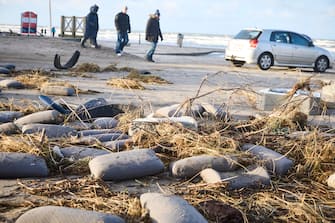 epa11044611 Locals inspect items from containers spillage  along the West coast at Tranum beach in North Jutland, Denmark, 26 December 2023. The contents of 46 lost containers from the ship Mayview Maersk wash ashore in North Jutland. The containers washed overboard during storm Pia.  EPA/Claus Bjoern Larsen  DENMARK OUT