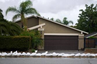 epa10811202 A driveway is lined with sandbags to prevent flooding as Tropical Storm Hilary arrives in Yucaipa, California, USA, 20 August 2023. Southern California is under a tropical storm warning for the first time in history as Hilary makes landfall. The last time a tropical storm made landfall in Southern California was 15 September 1939, according to the National Weather Service.  EPA/ALLISON DINNER