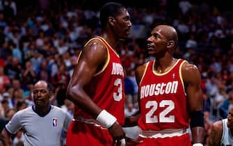 SAN ANTONIO - MAY 30:  Clyde Drexler #22 talks to Hakeem Olajuwon #34 of the Houston Rockets in Game Five of the Western Conference Finals during the 1995 NBA Playoffs at the Alamodome on May 30, 1995 in San Antonio. The Houston Rockets defeated the San Antonio Spurs 111-90.  NOTE TO USER: User expressly acknowledges and agrees that, by downloading and or using this photograph, User is consenting to the terms and conditions of the Getty Images License Agreement. Mandatory Copyright Notice: Copyright 1995 NBAE (Photo by Andrew D. Bernstein/NBAE via Getty Images)