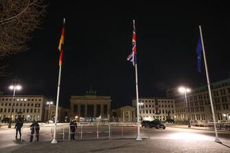 29 March 2023, Berlin: Police forces set up a fence on Pariser Platz in front of the Brandenburg Gate for King Charles III's visit to Berlin. Three flagpoles, which are not usually seen there, can also be seen. Photo: Joerg Carstensen/dpa (Photo by Joerg Carstensen/picture alliance via Getty Images)