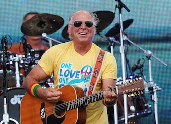 GULF SHORES, AL - JULY 11:  Musician Jimmy Buffett performs onstage at Jimmy Buffett & Friends: Live from the Gulf Coast, a concert presented by CMT at on the beach on July 11, 2010 in Gulf Shores, Alabama.  (Photo by Rick Diamond/Getty Images for CMT)