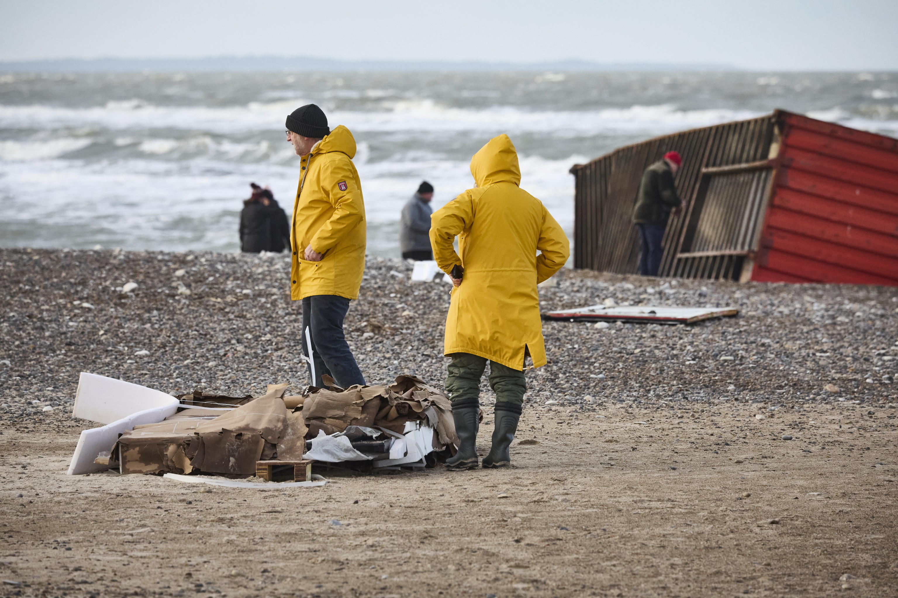 epa11044606 Locals inspect items from containers spillage  along the West coast at Tranum beach in North Jutland, Denmark, 26 December 2023. The contents of 46 lost containers from the ship Mayview Maersk wash ashore in North Jutland. The containers washed overboard during storm Pia.  EPA/Claus Bjoern Larsen  DENMARK OUT