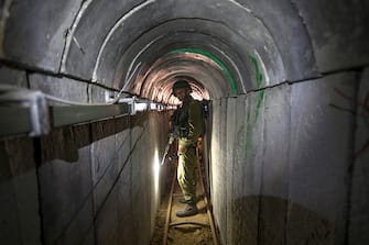 TOPSHOT - An Israeli army officer walks on July 25, 2014 during an army-organised tour in a tunnel said to be used by Palestinian militants from the Gaza Strip for cross-border attacks. Israel launched its military offensive aiming at destroying tunnels used by Gaza militants. AFP PHOTO / POOL / JACK GUEZ (Photo by JACK GUEZ / POOL / AFP) (Photo by JACK GUEZ/POOL/AFP via Getty Images)