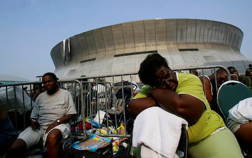 NEW ORLEANS, CA - SEPTEMBER 02:  A woman sleeps as the the long wait to escape destruction of the hurricane for a shelter in San Antonio,Texas during the aftermath of Hurricane Katrina Saturday, September 3, 2005 in New Orleans, Louisiana. (Photo by Keith Birmingham/MediaNews Group/Pasadena Star-News via Getty Images)