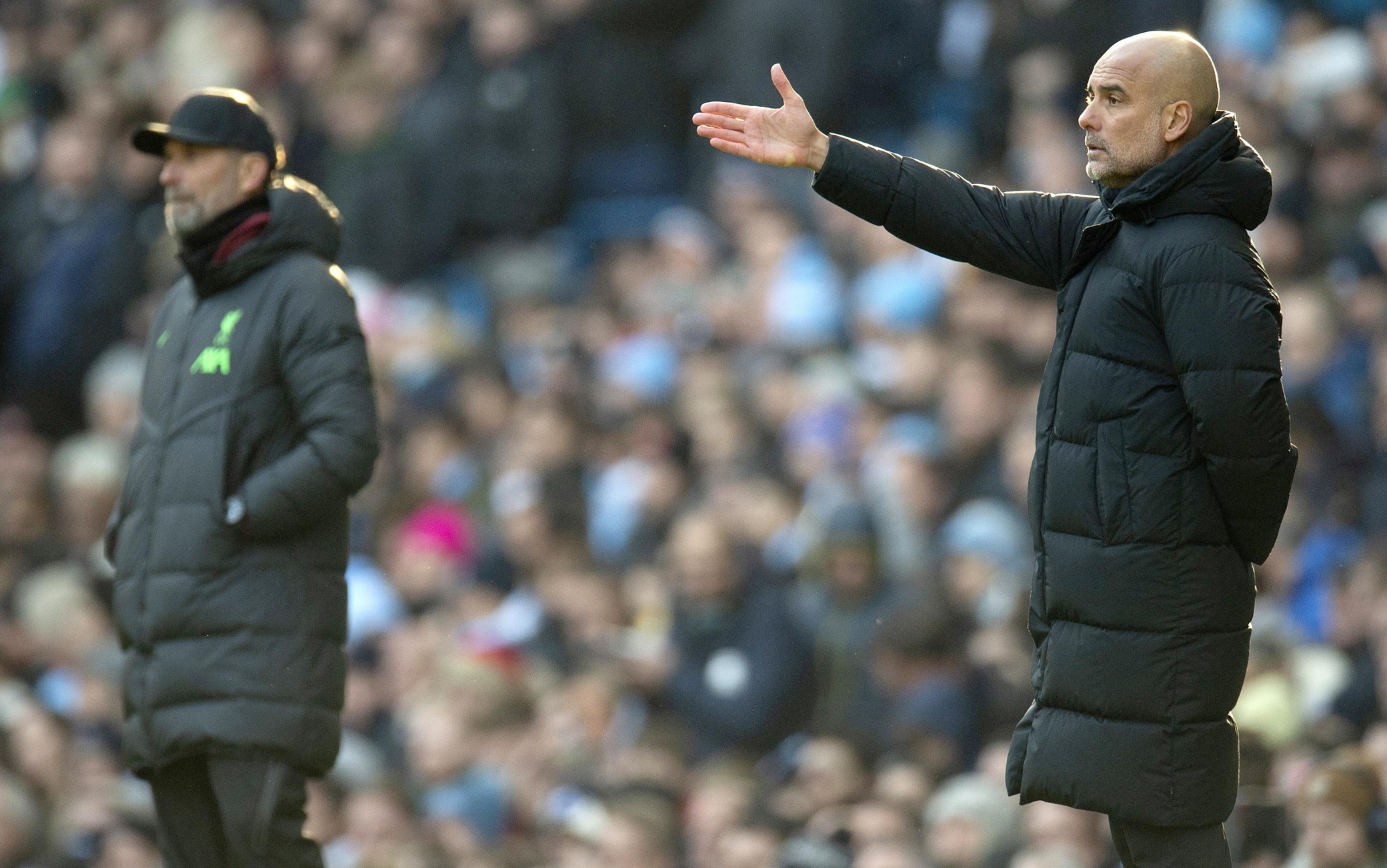 epa10994194 Manchester City manager Pep Guardiola (R) and Liverpool manager Juergen Klopp watch from the touchline during the English Premier League soccer match between Manchester City and Liverpool FC, in Manchester, Britain, 25 November 2023.  EPA/PETER POWELL EDITORIAL USE ONLY. No use with unauthorized audio, video, data, fixture lists, club/league logos, 'live' services or NFTs. Online in-match use limited to 120 images, no video emulation. No use in betting, games or single club/league/player publications.