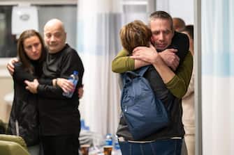 epa11147646 A handout photo made available by the IDF spokesperson shows Norberto Louis Har (2-L) and Fernando Simon Marman (R), two Israeli men freed during an Israeli operation in southern Gaza, being reunited with their families at Sheba Medical Center in Tel Hashomer, Israel, 12 February 2024. The Israeli Defense Forces (IDF) confirmed on 12 February that two Israeli hostages were rescued during an overnight operation in Rafah.  EPA/IDF Spokersperson HANDOUT  HANDOUT EDITORIAL USE ONLY/NO SALES HANDOUT EDITORIAL USE ONLY/NO SALES