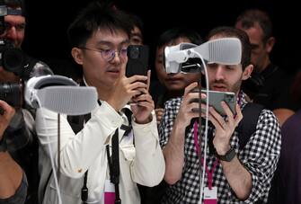 CUPERTINO, CALIFORNIA - JUNE 05: Members of the media inspect the new Apple Vision Pro headset during the Apple Worldwide Developers Conference on June 05, 2023 in Cupertino, California. Apple CEO Tim Cook kicked off the annual WWDC22 developer conference with the announcement of the new Apple Vision Pro mixed reality headset. (Photo by Justin Sullivan/Getty Images)