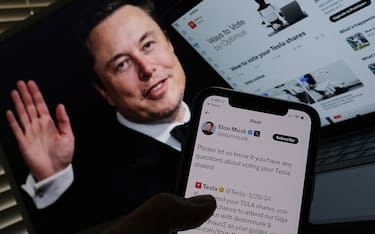 This illustration image created on June 12, 2024 in Los Angeles, shows South African businessman Elon Musk's campaign launched on X ahead of Tesla shareholders meeting in front of his picture on a screen. Electric vehicle company Tesla kept up the campaign to win last-minute votes ahead of the June 13 shareholder meeting that will weigh in on CEO Elon Musk's giant compensation package. "Tesla stockholders, time is running out," read a special webpage set up by the company for the annual meeting. Voting was set to conclude at 11:59 pm local time on Wednesday night. (Photo by Chris DELMAS / AFP) (Photo by CHRIS DELMAS/AFP via Getty Images)