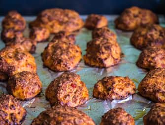 baked hot meatballs on a baking tray