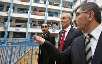 epa04620995 Quartet Representative to the Middle East, Tony Blair (R), visits a UN-run school sheltering Palestinians, whose houses were destroyed as a result of Israel's Operation Protective Edge, in Gaza, 15 February 2015. Blair made the trip to Gaza in part to see for himself the damage sustained during Israel's Operation Protective Edge, which led to the deaths of more than 2000 Palestinians during the 51 day offensive on the coastal strip July August 2014, and to meet with Palestinian Government and UN officials.  EPA/SUHAIB SALEM / REUTERS 0