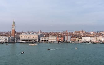Buildings on the banks of the Grand Canal, including St. Mark's Campanile, left, in Venice, Italy, on Thursday, March 14, 2024. Venice collected 37 million in overnight tourist taxes in 2023, with hotels charging guests anywhere between 1 and 5. Photographer: Nathan Laine/Bloomberg via Getty Images