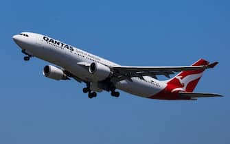 SYDNEY, AUSTRALIA - FEBRUARY 22: A Qantas plane takes off from Sydney International Airport on February 22, 2024 in Sydney, Australia. Qantas has demonstrated a significant financial turnaround, reporting a record $2.47 billion profit for the 2022-23 fiscal year, marking a stark change from the previous year's $1.86 billion loss. The airline's strong performance was attributed to robust travel demand and high ticket prices, with domestic earnings before interest and taxes (EBIT) jumping to 18.2%, representing a 50% increase in profit margins over the past six years. The company's return on invested capital also increased to 103.6%, reflecting its improved financial position and operational performance. (Photo by Jenny Evans/Getty Images)