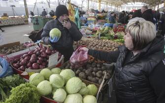 epa09846837 Local people shop at Privoz Market in the south Ukrainian city of Odesa, Ukraine, 24 March 2022, amid the Russian invasion of Ukraine. The famous historical Privoz Market, located in downtown Odesa, is the largest food market in the city and was founded in 1827. On 24 February, Russian troops had entered Ukrainian territory in what the Russian president declared a 'special military operation', resulting in fighting and destruction in the country, a huge flow of refugees, and multiple sanctions against Russia.  EPA/STEPAN FRANKO