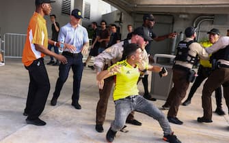 MIAMI GARDENS, FLORIDA - JULY 14: Police officers try to arrest a Colombian fan outside the stadium the CONMEBOL Copa America 2024 Final match between Argentina and Colombia at Hard Rock Stadium on July 14, 2024 in Miami Gardens, Florida. (Photo by Maddie Meyer/Getty Images)