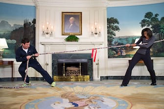 WASHINGTON, DC - JANUARY 25: In this handout provided by the White House, first lady Michelle Obama (R) participates in a tug of war with Jimmy Fallon in the Blue Room of the White House January 25, 2012 in Washington, DC.  The taping of "Late Night with Jimmy Fallon" marked the second anniversary of the "Let's Move!" initiative.  (Photo by Chuck Kennedy/The White House via Getty Images)
