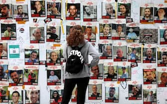 epa11147949 A woman looks at a wall displaying pictures of hostages held by Hamas in Gaza, at the Hostages Square next to the Kirya military military base, in Tel Aviv, Israel, 12 February 2024. According to a statement released by the Israeli Defense Forces (IDF), two Israeli hostages were rescued during an overnight operation in Rafah, southern Gaza Strip. More than 28,300 Palestinians and over 1,300 Israelis have been killed, according to the Palestinian Health Ministry and the Israel Defense Forces (IDF), since Hamas militants launched an attack against Israel from the Gaza Strip on 07 October 2023, and the Israeli operations in Gaza and the West Bank which followed it.  EPA/ATEF SAFADI