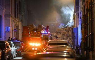 Rescue vehicles gather at the scene where a building collapsed in the southern French port city of Marseille early on April 9, 2023. - A building in the southern French port city of Marseille collapsed, police told AFP early on April 9, though it was unclear whether there were any victims. (Photo by NICOLAS TUCAT / AFP) (Photo by NICOLAS TUCAT/AFP via Getty Images)