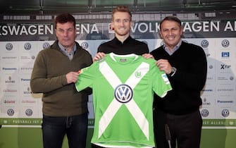 WOLFSBURG, GERMANY - FEBRUARY 04: Head coach Dieter Hecking (L) ,  Andre Schuerrle (C) and Manager Klaus Allofs (R) of Wolfsburg poses for the media during the Press Conference at Volkswagen Arena on February 4, 2015 in Wolfsburg, Germany.  (Photo by Oliver Hardt/Bongarts/Getty Images)