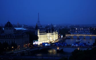 PARIS, FRANCE - JULY 26: A general view of the Paris Skyline as boats are seen passing in front of  the Conciergerie on the River Seine during the opening ceremony of the Olympic Games Paris 2024 on July 26, 2024 in Paris, France.  (Photo by Dan Mullan/Getty Images)