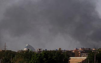 Smoke billows in the distance in Khartoum on May 22, 2023, as fighting between two rival generals persists. Gunfire and explosions rocked Sudan's capital on May 22 morning hours before a one-week humanitarian ceasefire was due to take effect, the latest after a series of truces that have all been violated. (Photo by AFP) (Photo by -/AFP via Getty Images)