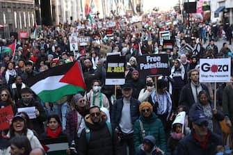 epa10970006 People participate in the Pro-Palestinian march in London, Britain, 11 November 2023. A coalition of groups are behind the march including the Palestine Solidarity Campaign, Friends of Al-Aqsa, Stop the War Coalition, Muslim Association of Britain, Palestinian Forum in Britain and Campaign for Nuclear Disarmament. The route for the march was changed to avoid any clashes with the commemorations for Armistice Day at the Cenotaph. Thousands of Israelis and Palestinians have died since the militant group Hamas launched an unprecedented attack on Israel from the Gaza Strip on 07 October, and the Israeli strikes on the Palestinian enclave which followed it.  EPA/ANDY RAIN